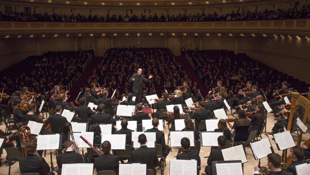 The orchestra performing at Carnegie Hall